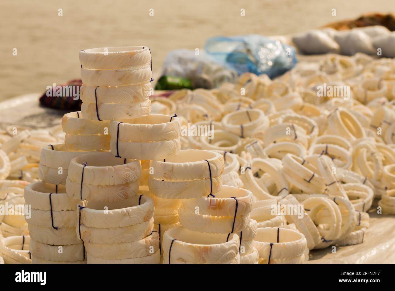 shankha or white bangles made of conch shells being sold near sea beach of digha. These bangles are traditional attire for married bengali women Stock Photo