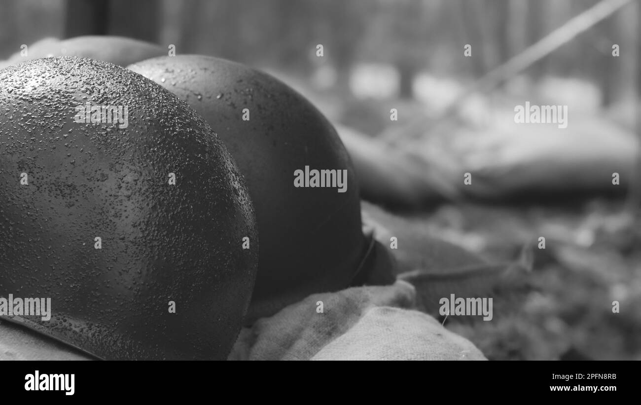 WWII American Metal Helmets Of United States Army Infantry Soldier At World War II. Helmets Near Camping Tent In Forest Camp Stock Photo