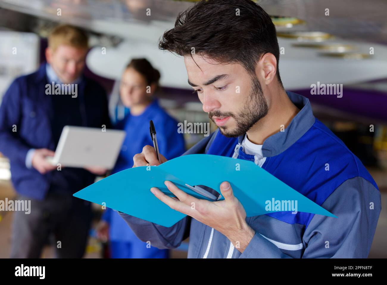 airplane engineer taking notes on notepad Stock Photo
