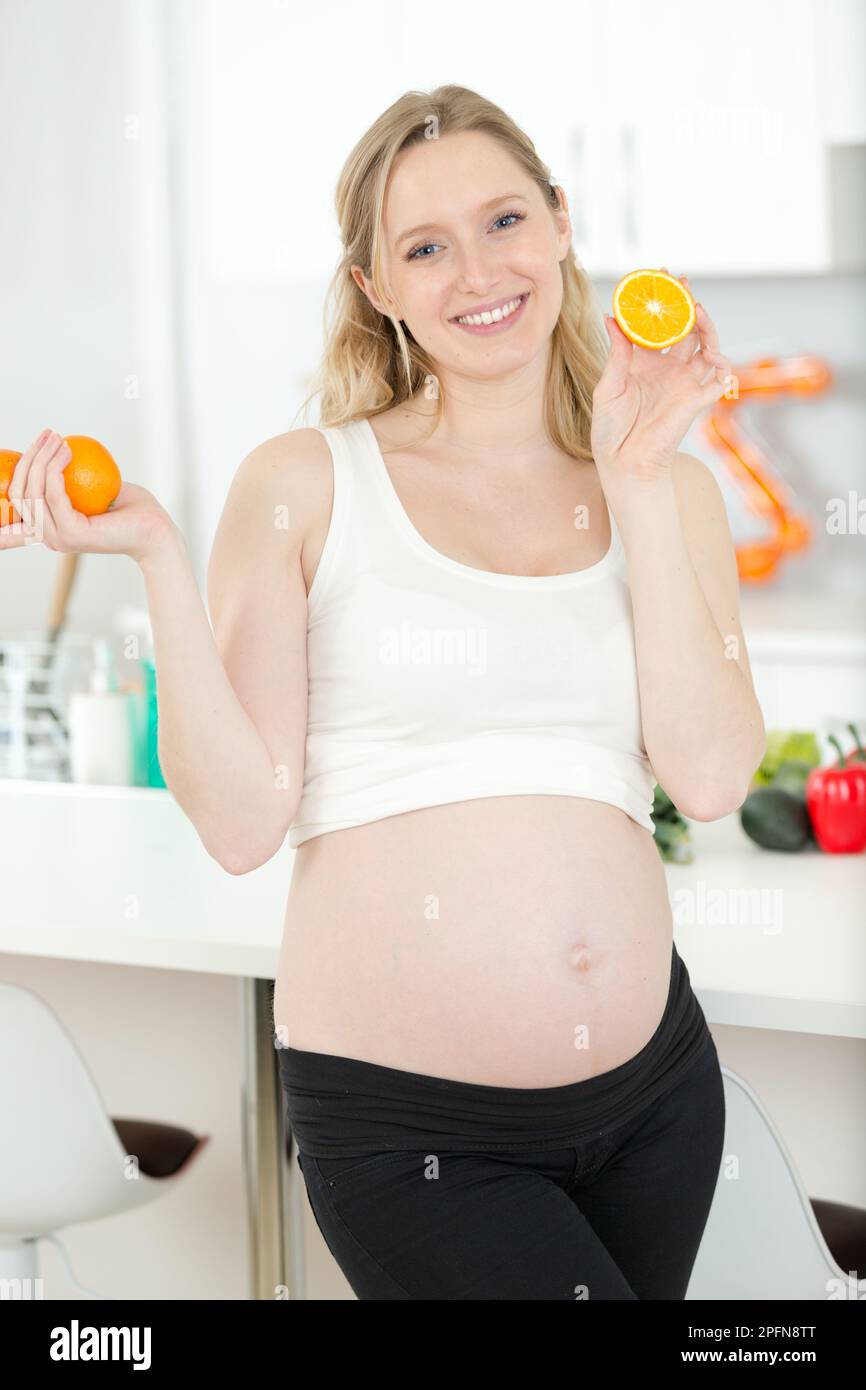 pregnant woman with glass of orange juice in the kitchen Stock Photo ...