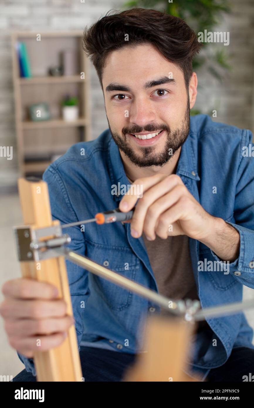 happy man and do it yourself furniture assembly Stock Photo Alamy