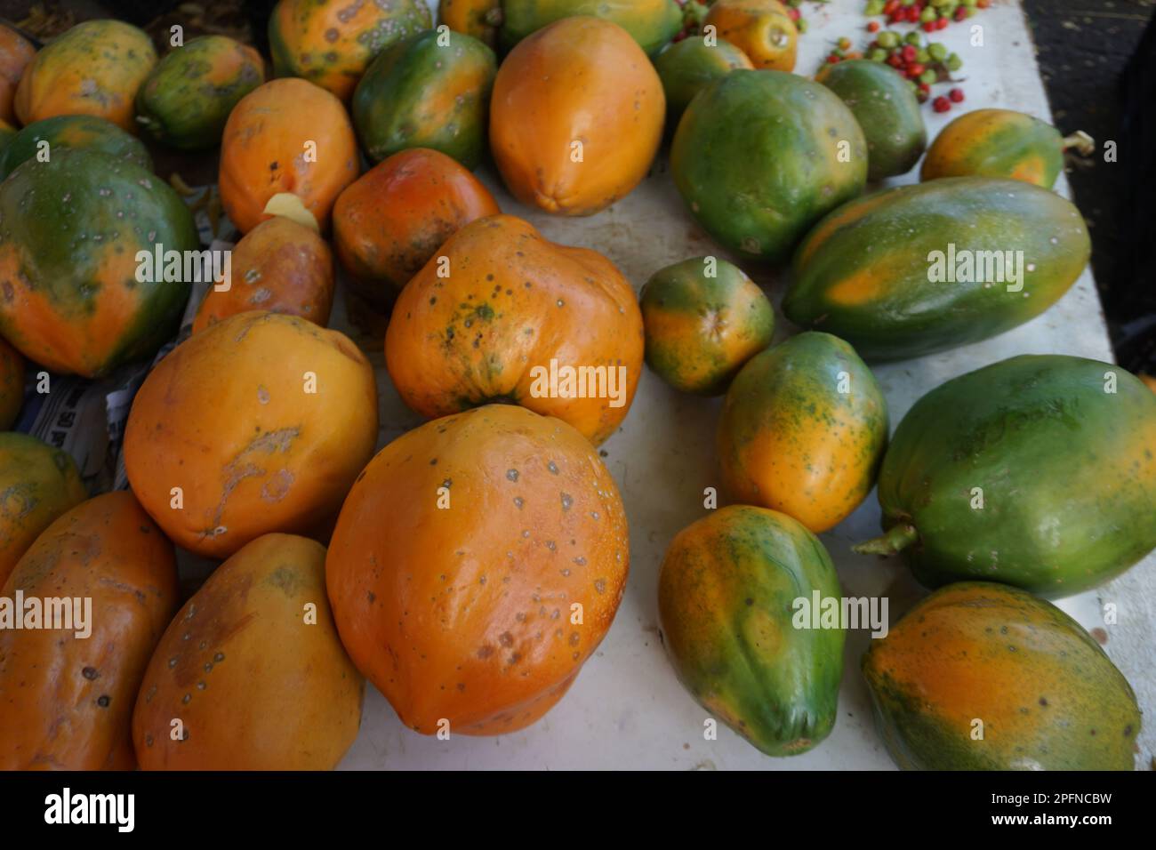 colorful papayas on display at the outdoor market on the tropical island of La Réunion, France Stock Photo