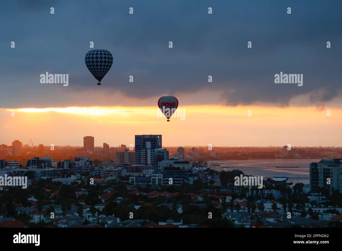 Two Hot Air Balloons flying over Port Melbourne at sunrise