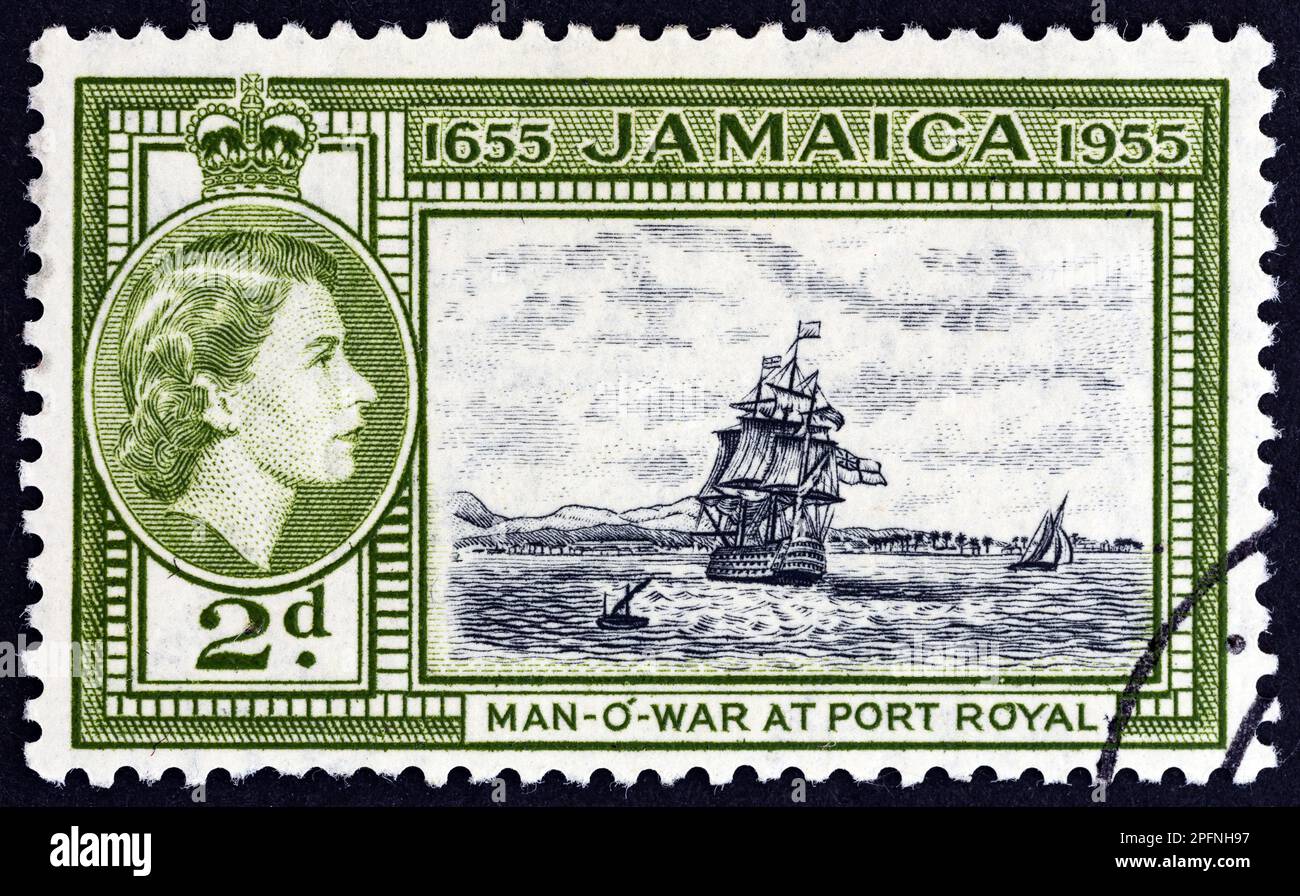 JAMAICA - CIRCA 1955: A stamp printed in Jamaica shows H.M.S. Britannia at Port Royal and Queen Elizabeth II, circa 1955. Stock Photo