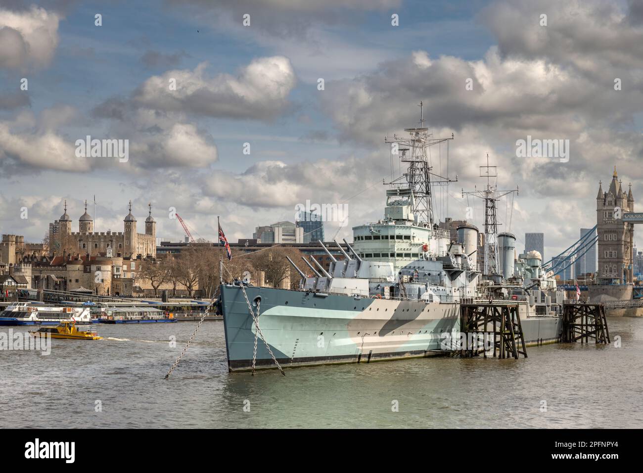 HMS Belfast moored on the River Thames alongside The Queens Walk in the Pool of London, Southwark. HMS Belfast is a Town-Class light cruiser that was Stock Photo