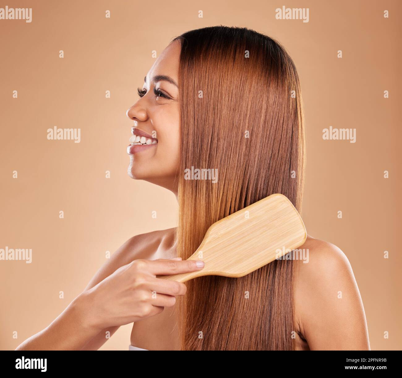 Beauty, woman and brush hair for growth and shine for straight texture on a brown background