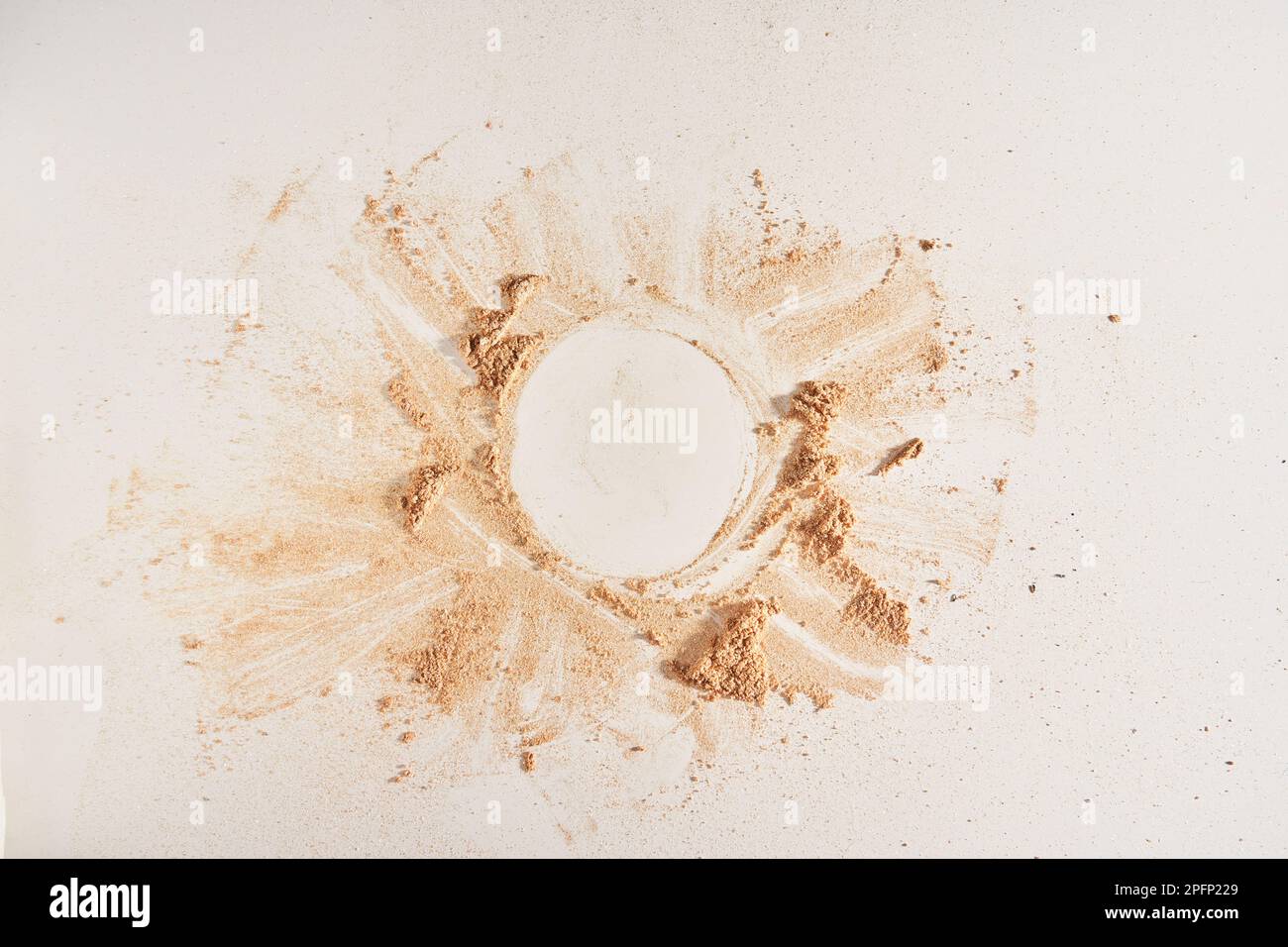 A neutral-colored face powder scattered on the surface in the form of a ...