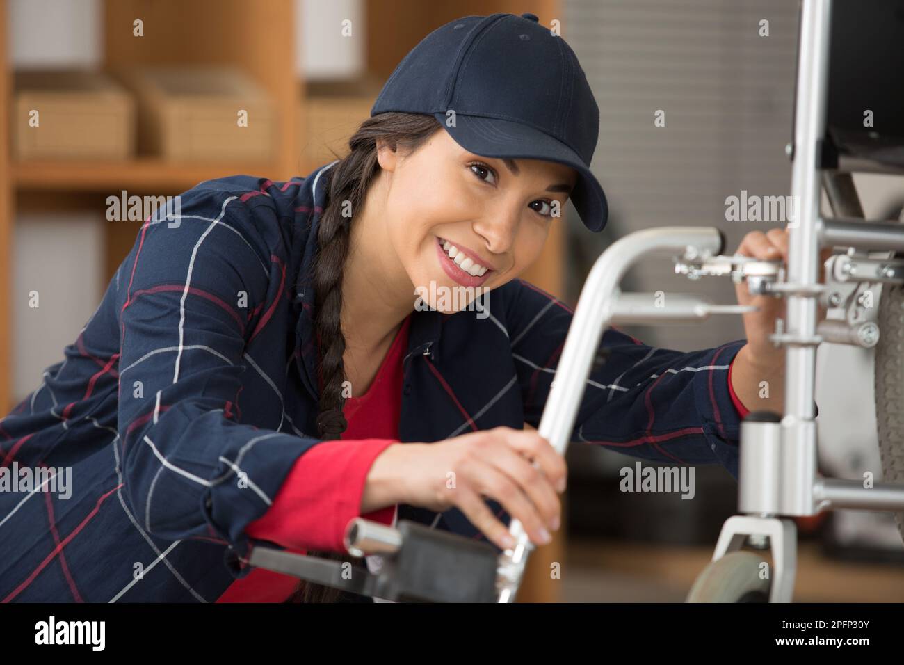 a female plumber working on central heating boiler Stock Photo