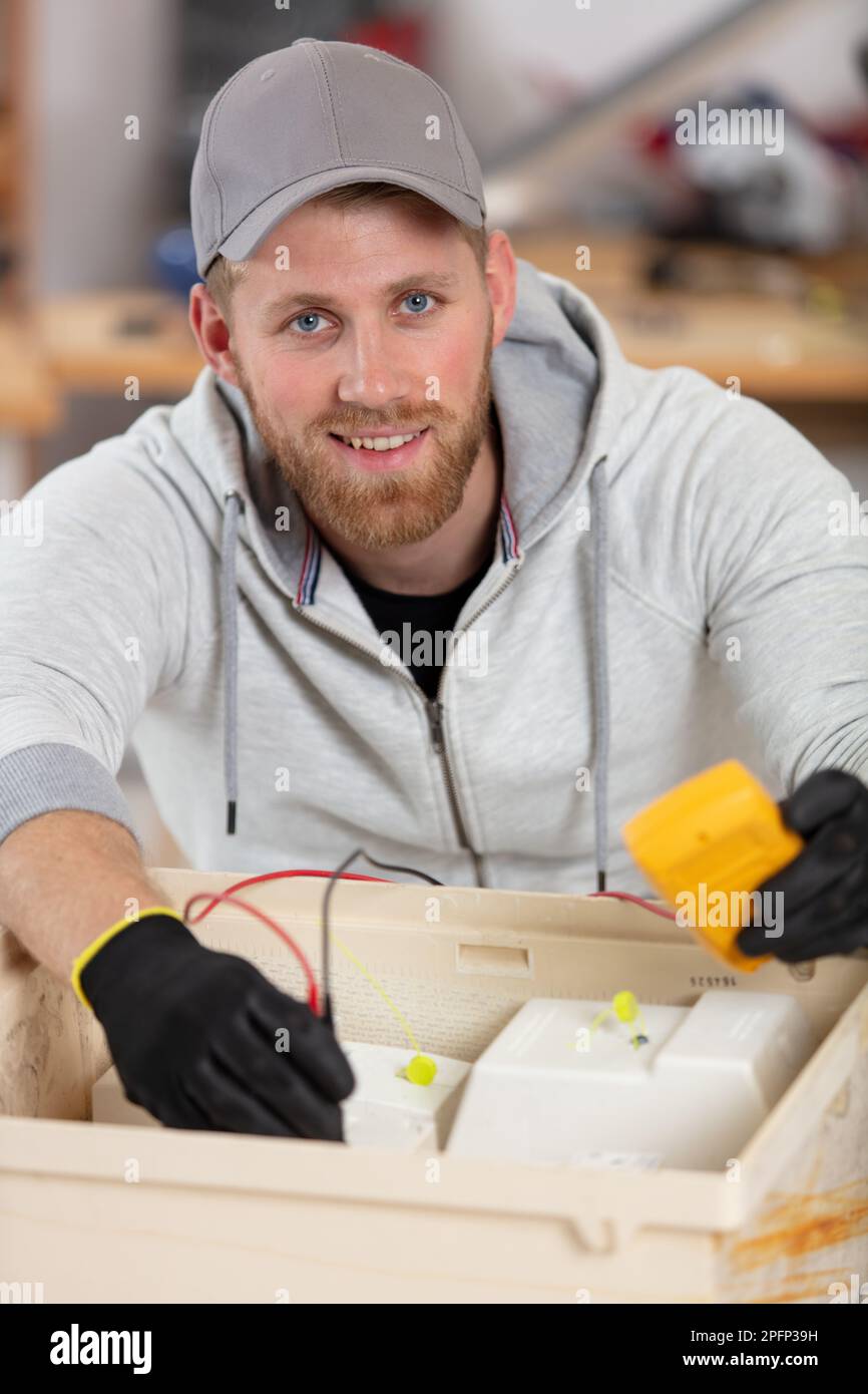 electrician testing electricity box with multimeter Stock Photo Alamy