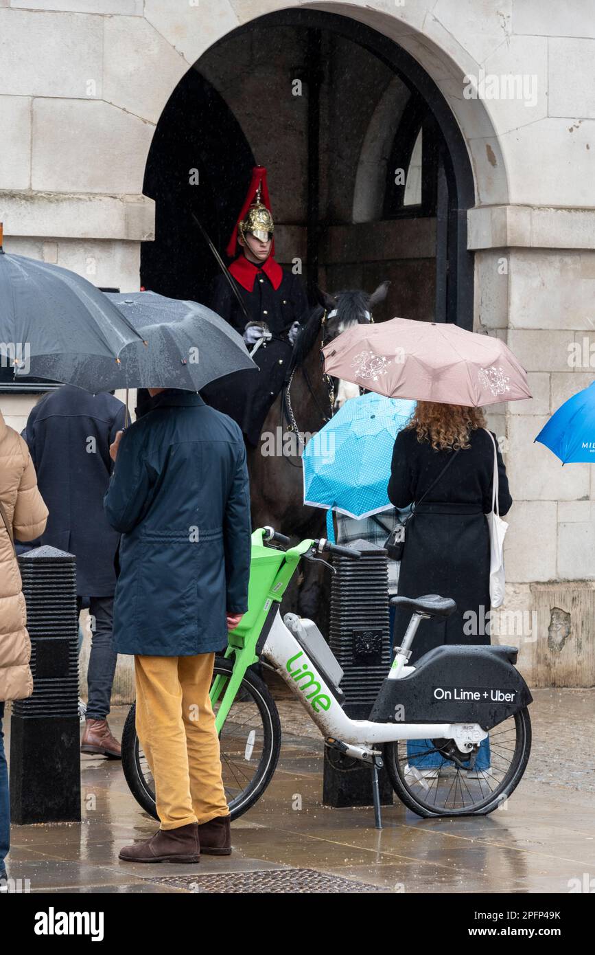 Westminster, London, UK. 18th Mar, 2023. The day has begun wet and overcast. A number of hire scheme e-bikes have been left by London landmarks. Horse Guards. Stock Photo