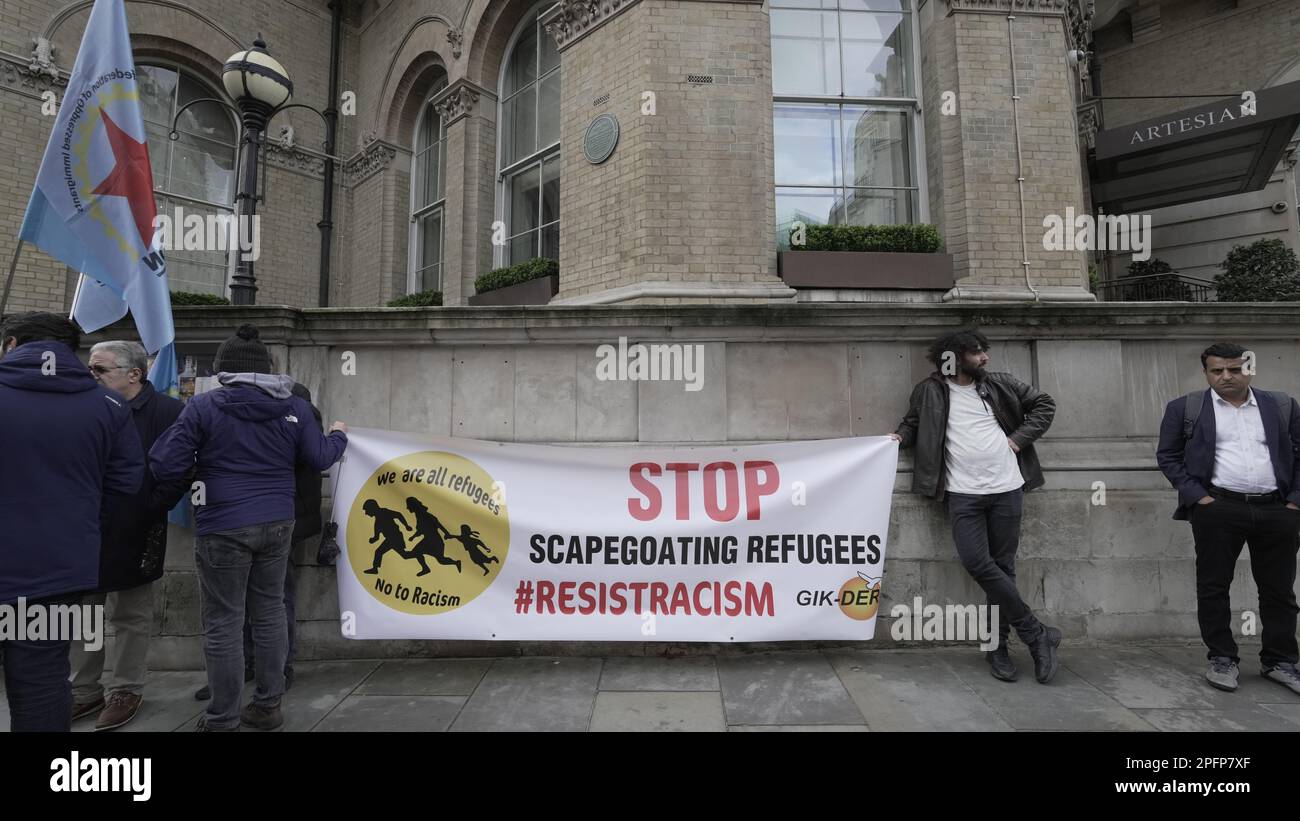 London, UK. 18th March, 2023.Two people from Resist Racism with banner ...