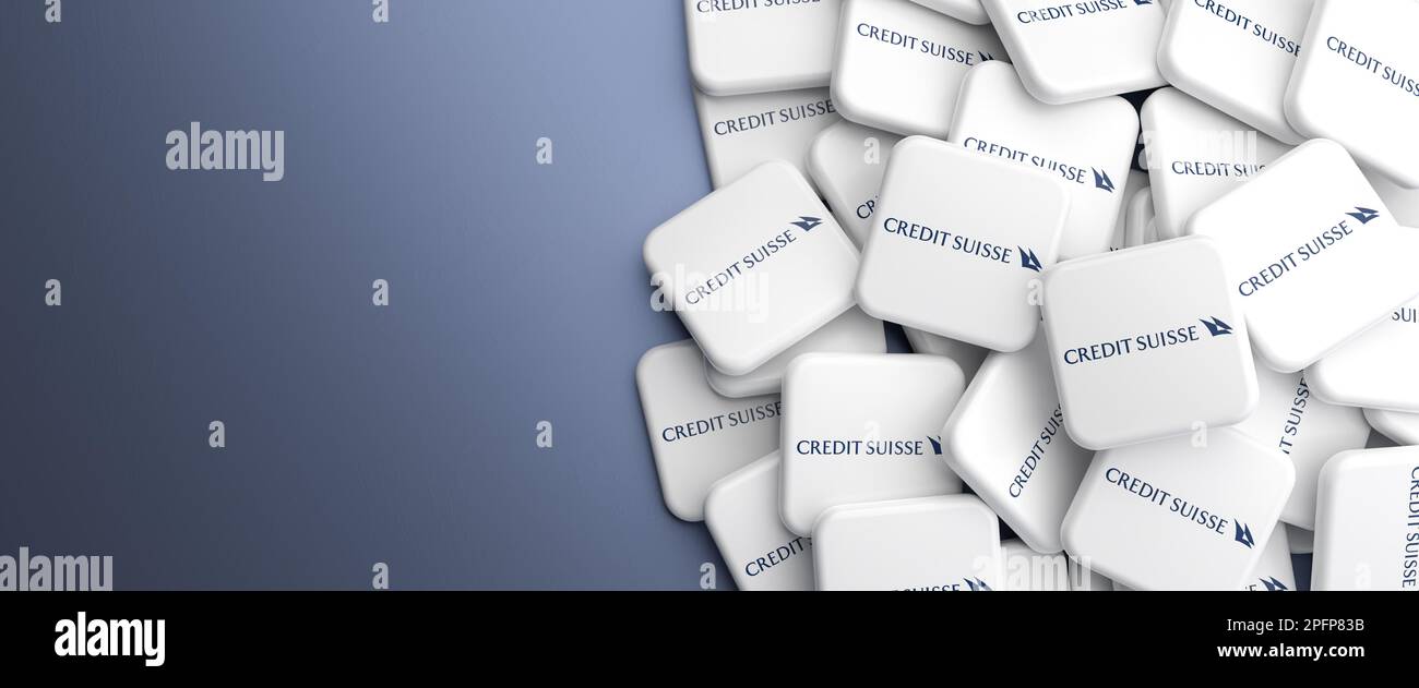 Logos of Credit Suisse Bank on a heap on a table. Copy space. Web banner format. Stock Photo