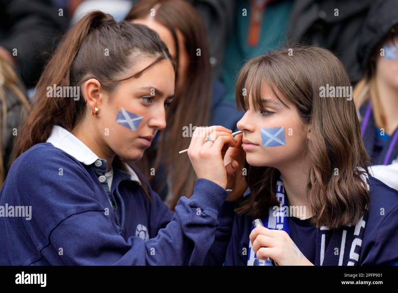 Edinburgh, UK. 18th Mar, 2023. Scotland fans apply face paint during