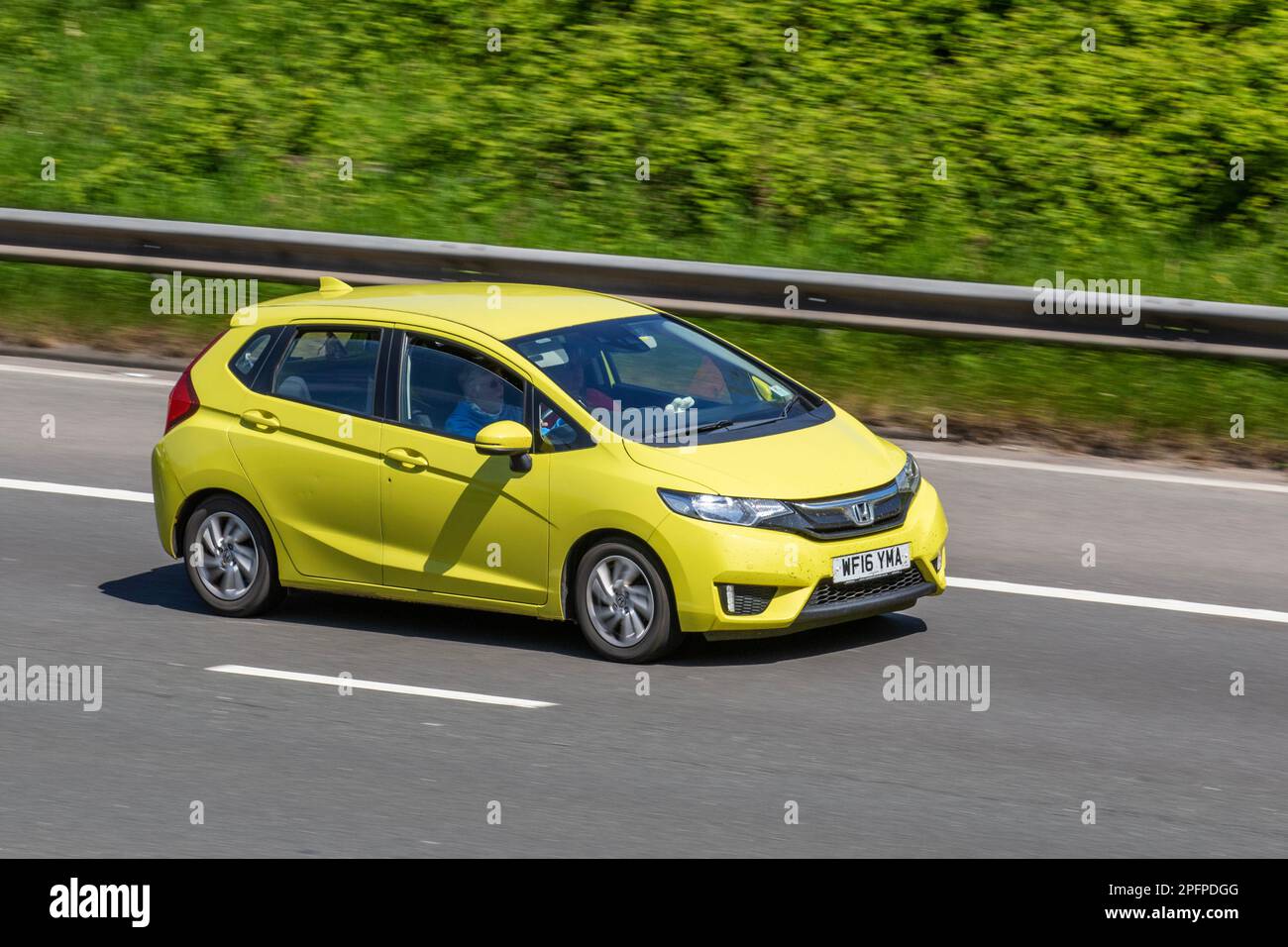 2016 (16) Yellow Honda Jazz SE I-VTEC; travelling on the M61 motorway, UK Stock Photo