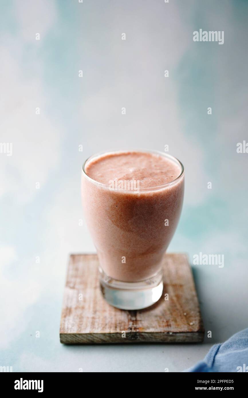 Healthy nutritious chikoo or Sapota milkshake served in a glass, selective focus Stock Photo