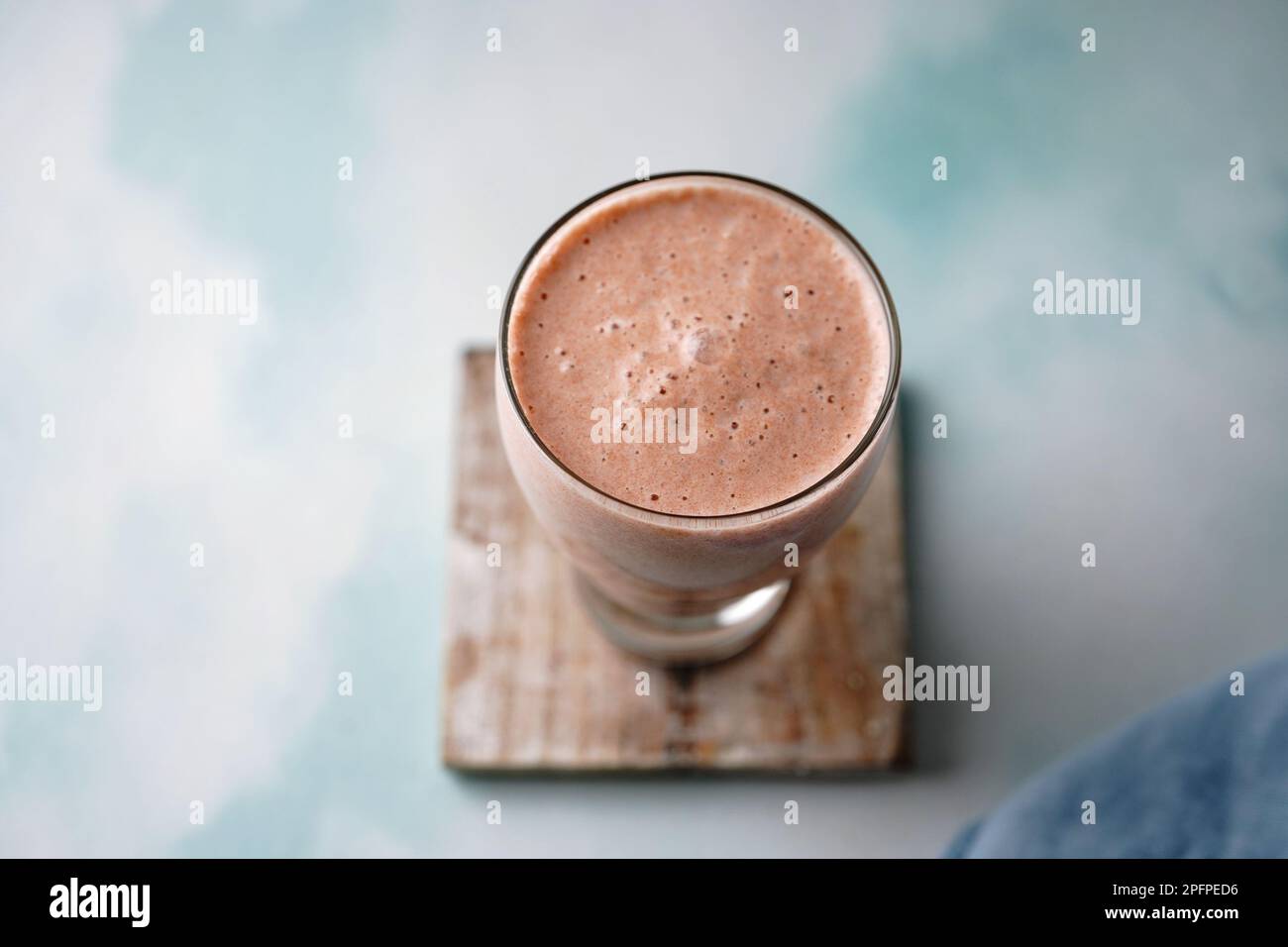 Healthy nutritious chikoo or Sapota milkshake served in a glass, selective focus Stock Photo