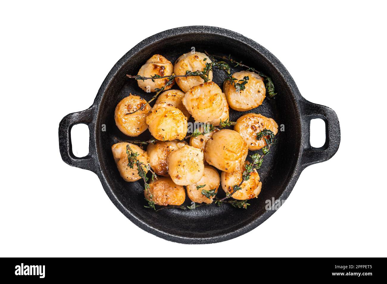 Scallops seared in garlic, thyme and butter served in cast iron skillet. Isolated on white