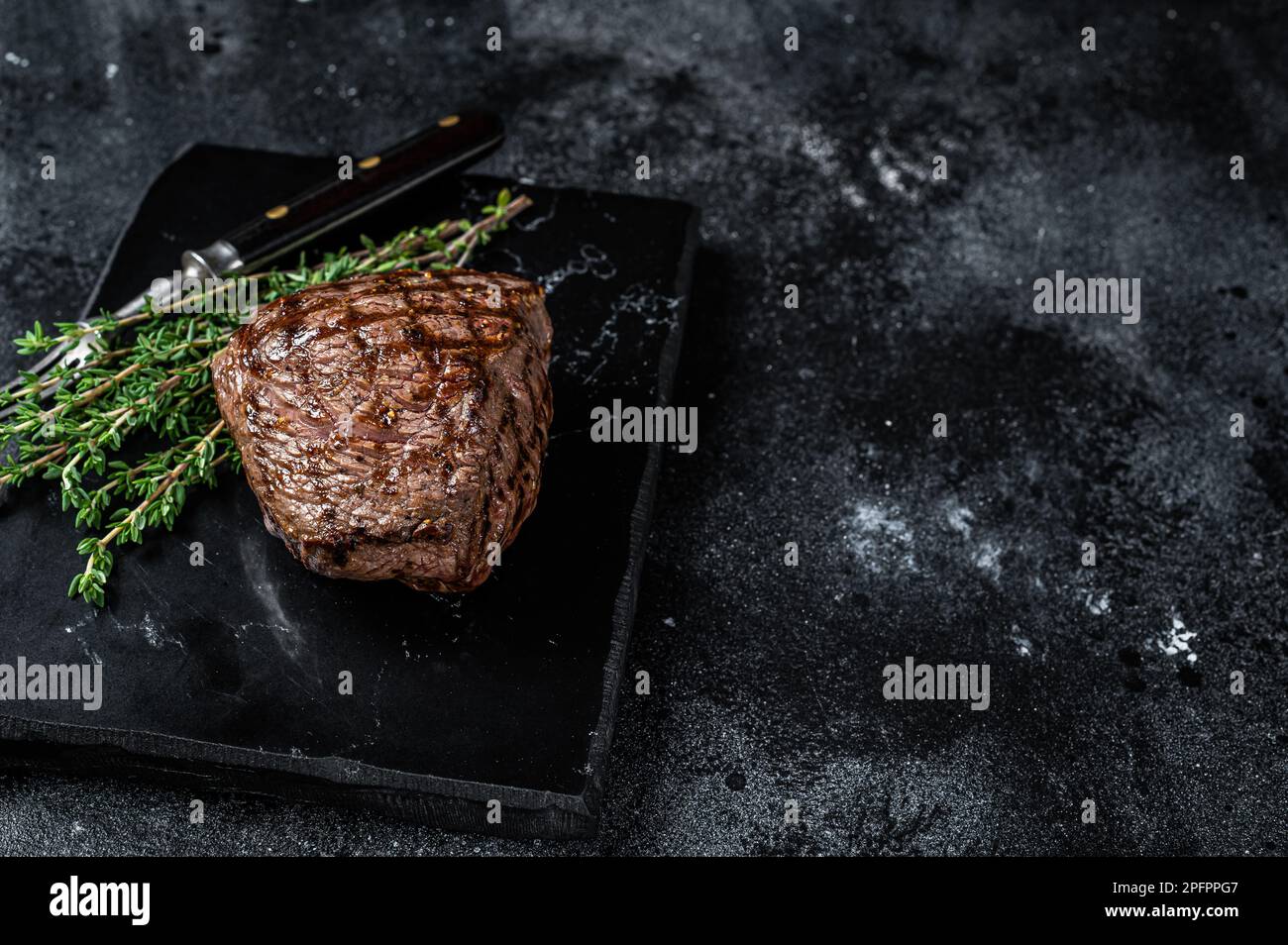 Grilled Rump steak with spices, cooked beef meat. Black background. Top ...