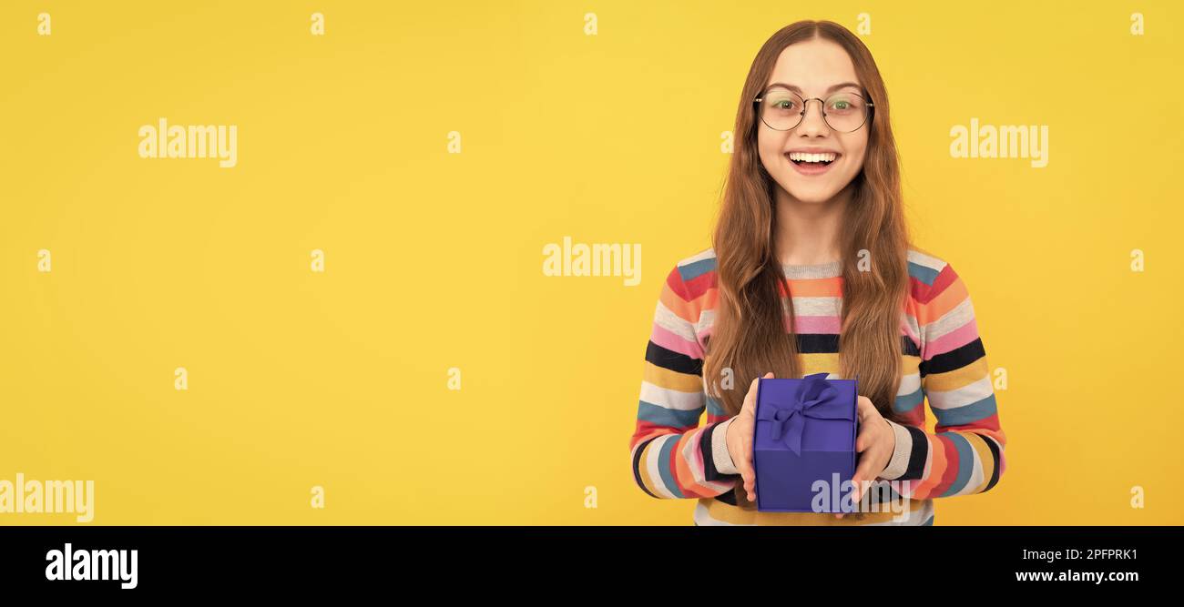 happy birthday holiday. black friday discount. seasonal sales. cheerful teen girl with box. Child with birthday gift, horizontal poster. Banner header Stock Photo
