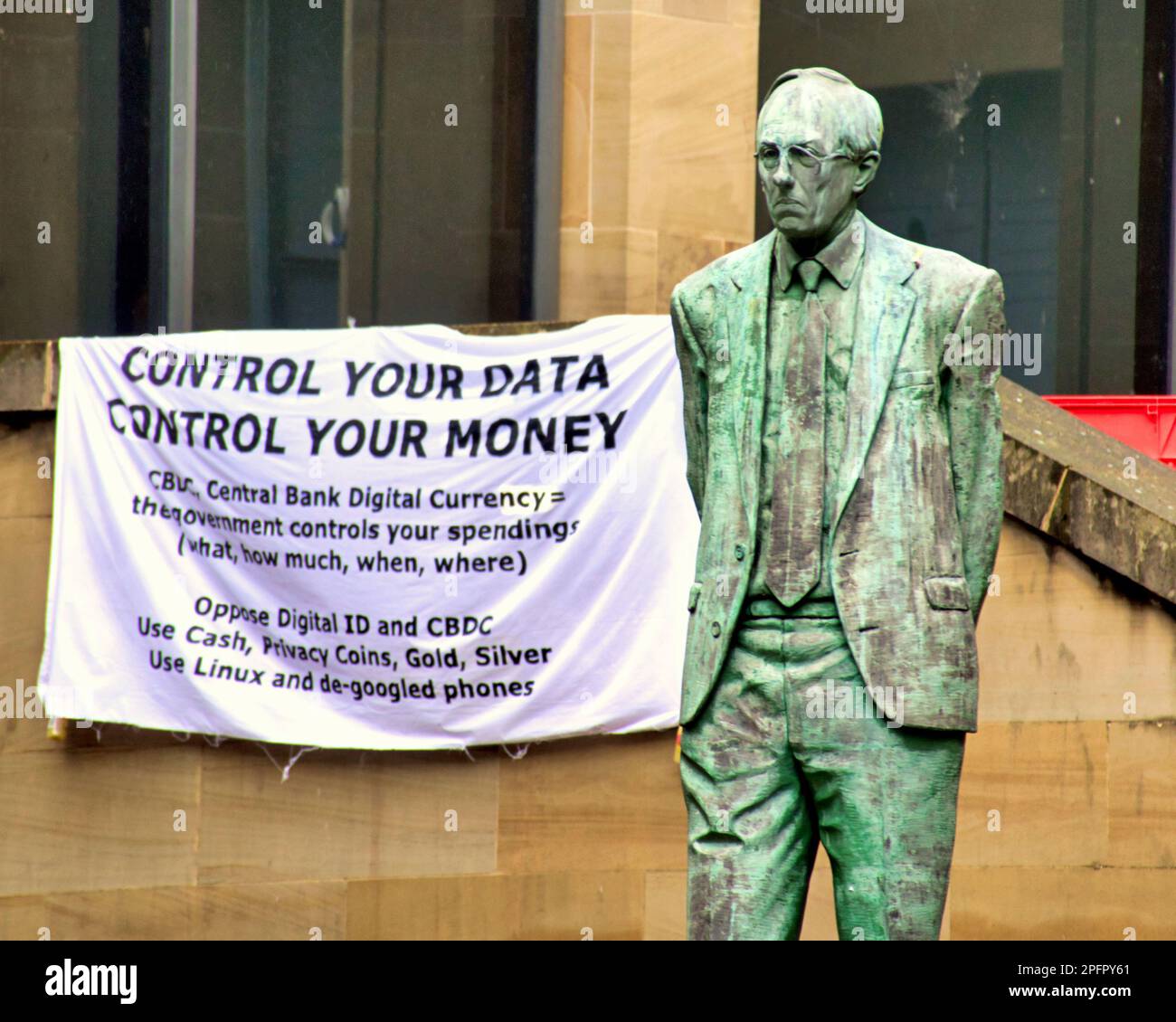 Glasgow, Scotland, UK 18th March, 2023. Central bank digital currency (CBDC) protest on the democracy spot of Glasgow, the Buchanan steps of the royal concert hall with the donald dewar statue, saw a former councillor among the speakers against the big brother currency grab. Credit Gerard Ferry/Alamy Live News Stock Photo