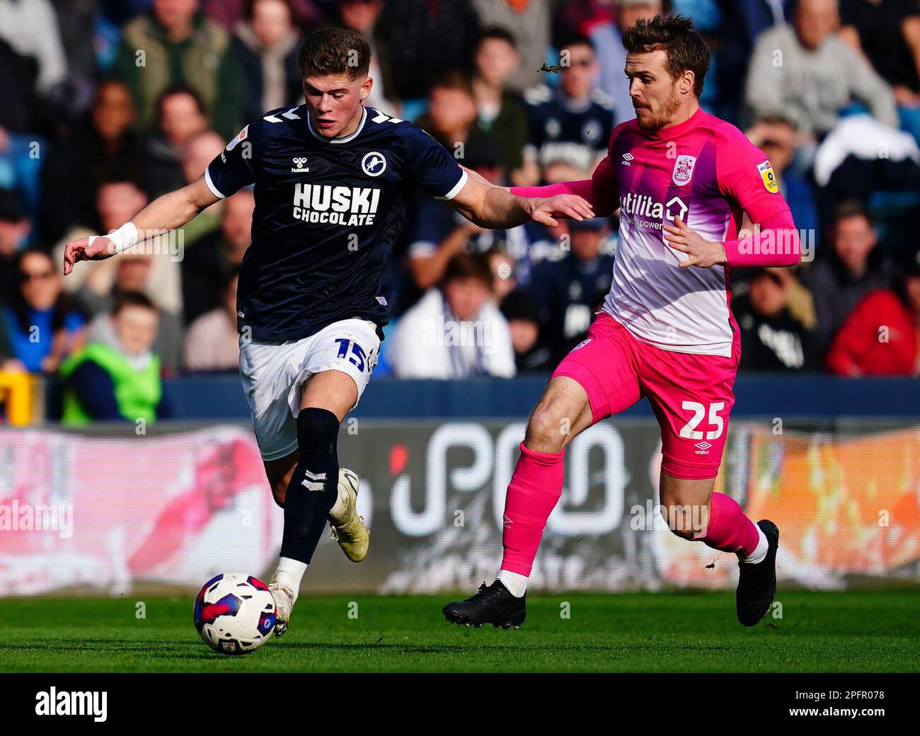 Millwall's Charlie Cresswell (left) and Huddersfield Town's Danny Ward battle for the ball during the Sky Bet Championship match at The Den, London. Picture date: Saturday March 18, 2023. Stock Photo