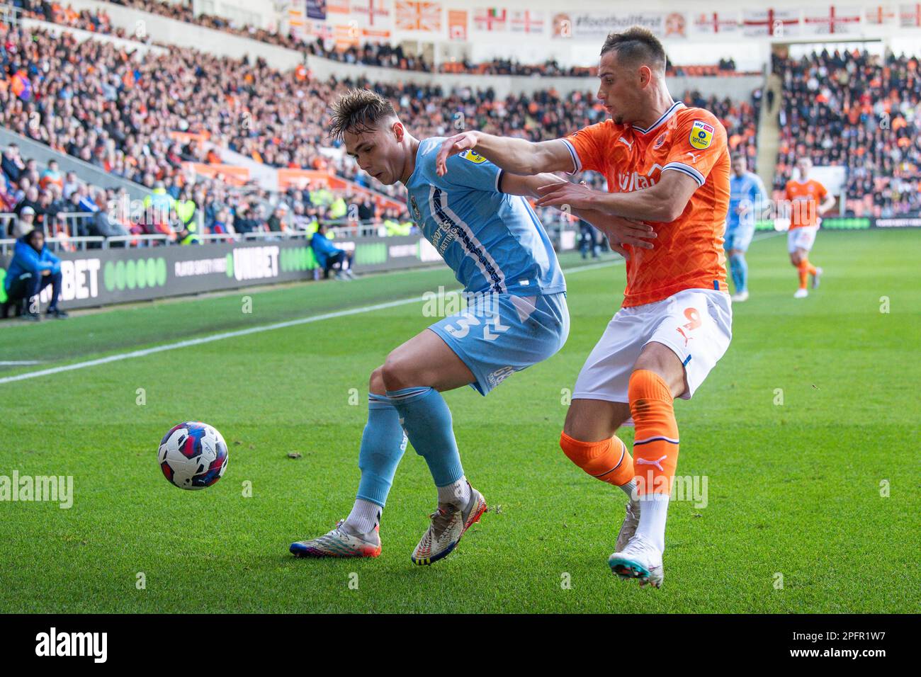 Jerry Yates #9 of Blackpool and battles for the ball with Callum Doyle #3 of Coventry City during the Sky Bet Championship match Blackpool vs Coventry City at Bloomfield Road, Blackpool, United Kingdom, 18th March 2023  (Photo by Craig Thomas/News Images) Stock Photo