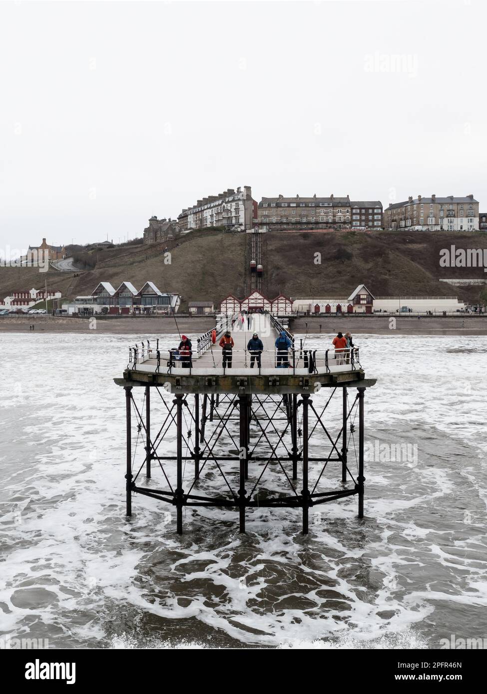 An aerial view from the North Sea of the Victorian Grade 2 Listed structure of Saltburn by the Sea Pier with crashing waves Stock Photo
