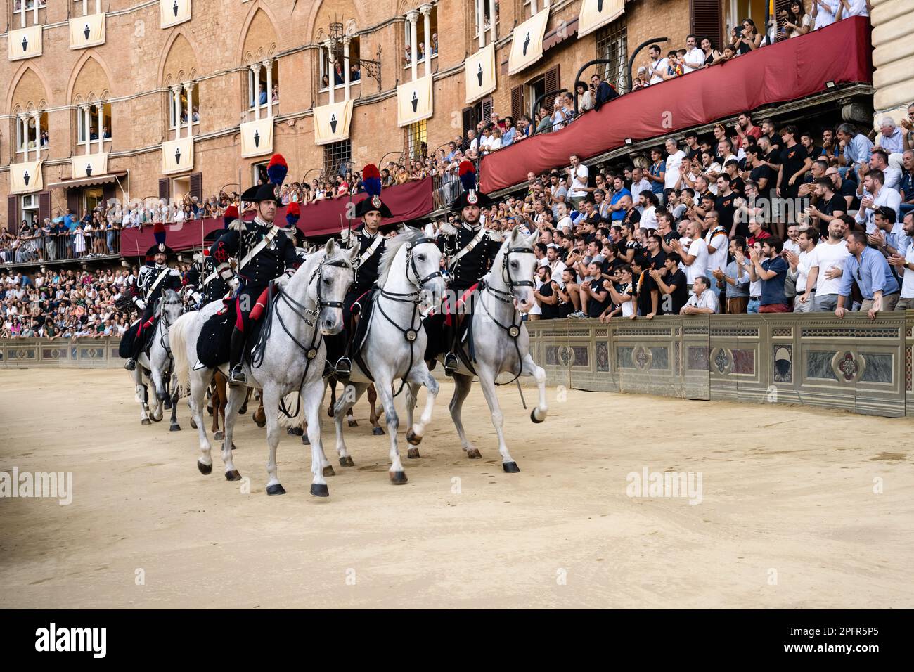 Siena, Italy - August 15 2022: Performance of the Carabinieri a Cavallo Mounted Police at the Prova Trial Race of the Palio di Siena. Stock Photo