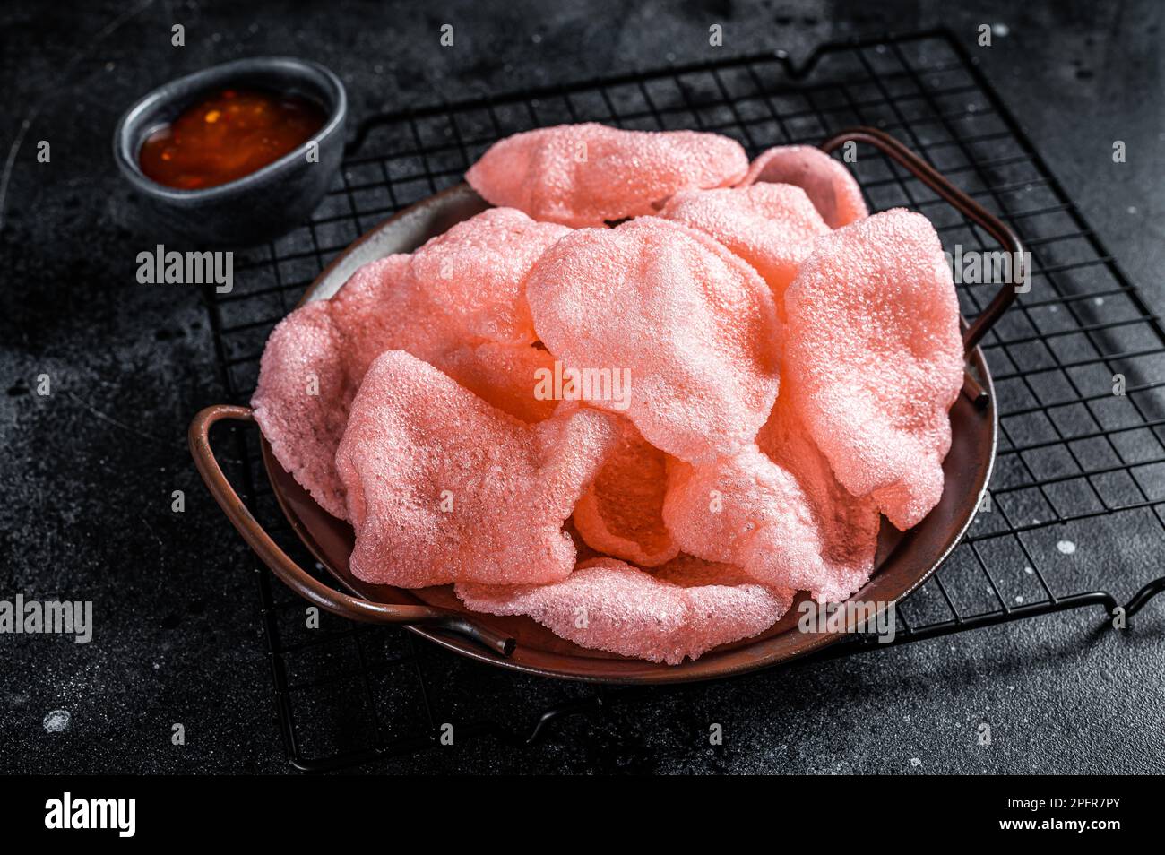 Vietnamese prawn shrimp crackers, chips, kerupuk. Asian fastfood. Black