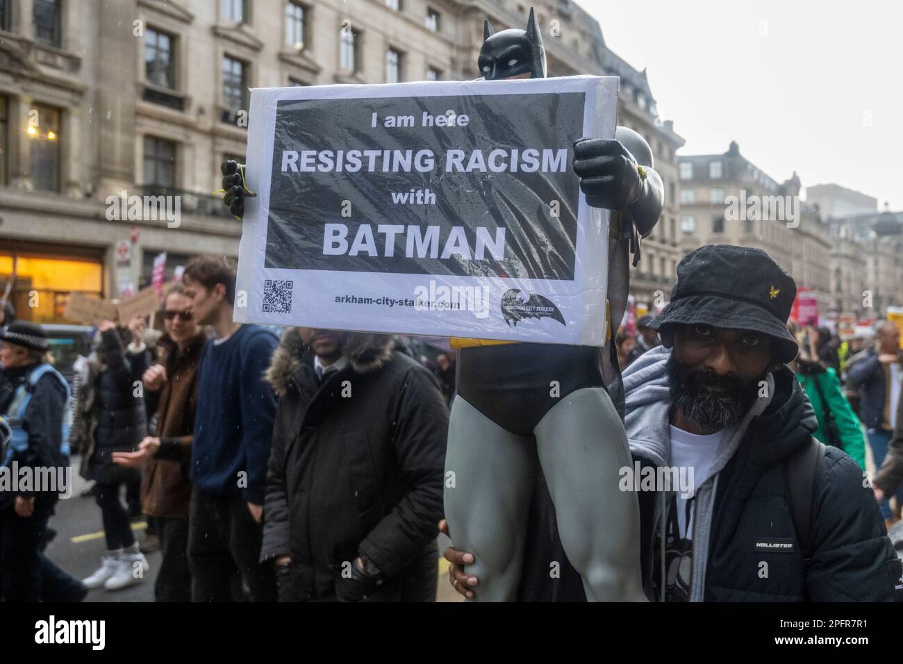 London, UK.  18 March 2023.  A man with a Batman character in Regent Street takes part in a 'Resist Racism' demonstration, marching from Portland Place to a rally in Westminster, as part of an international day of action to mark United Nations anti-racism day  Credit: Stephen Chung / Alamy Live News Stock Photo