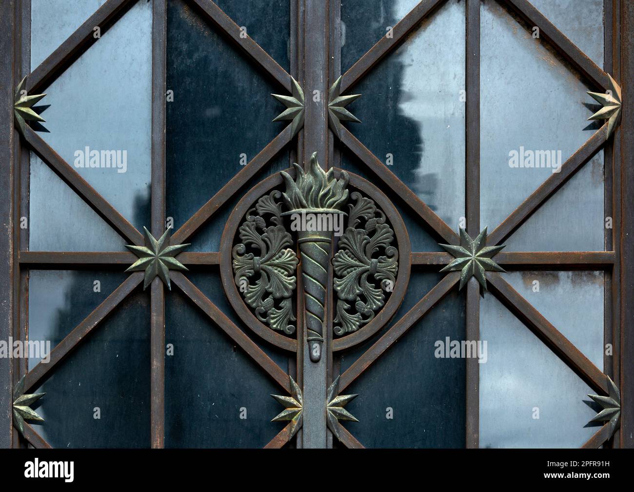 Shot in black and white and color detail on the facade of this historic building representing some character, animal or flower. Set at Barcelona Stock Photo