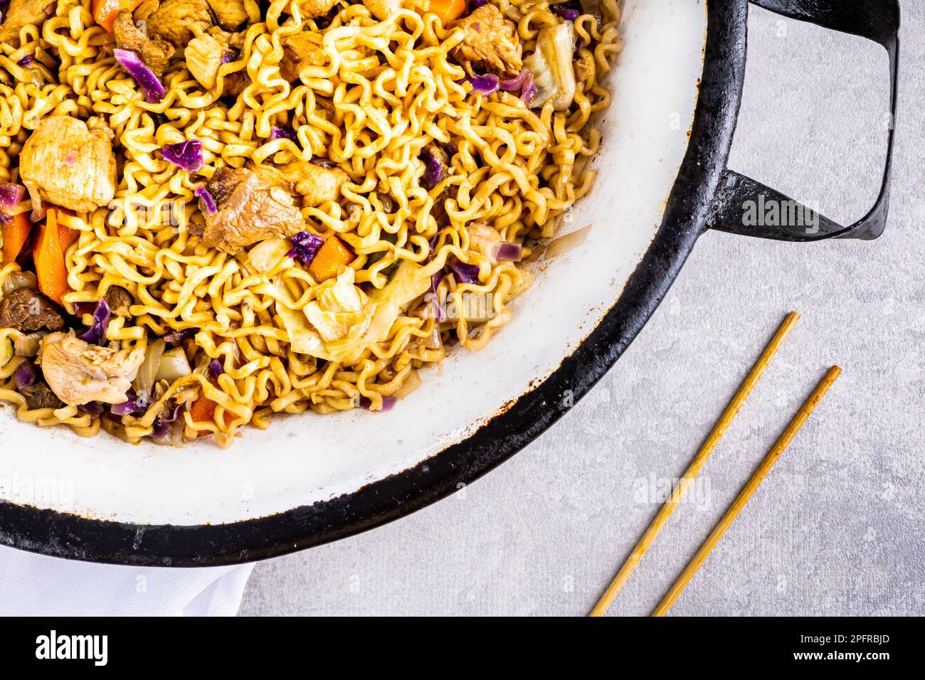 Japanese yakisoba with stirfried noodles in white metallic pan on