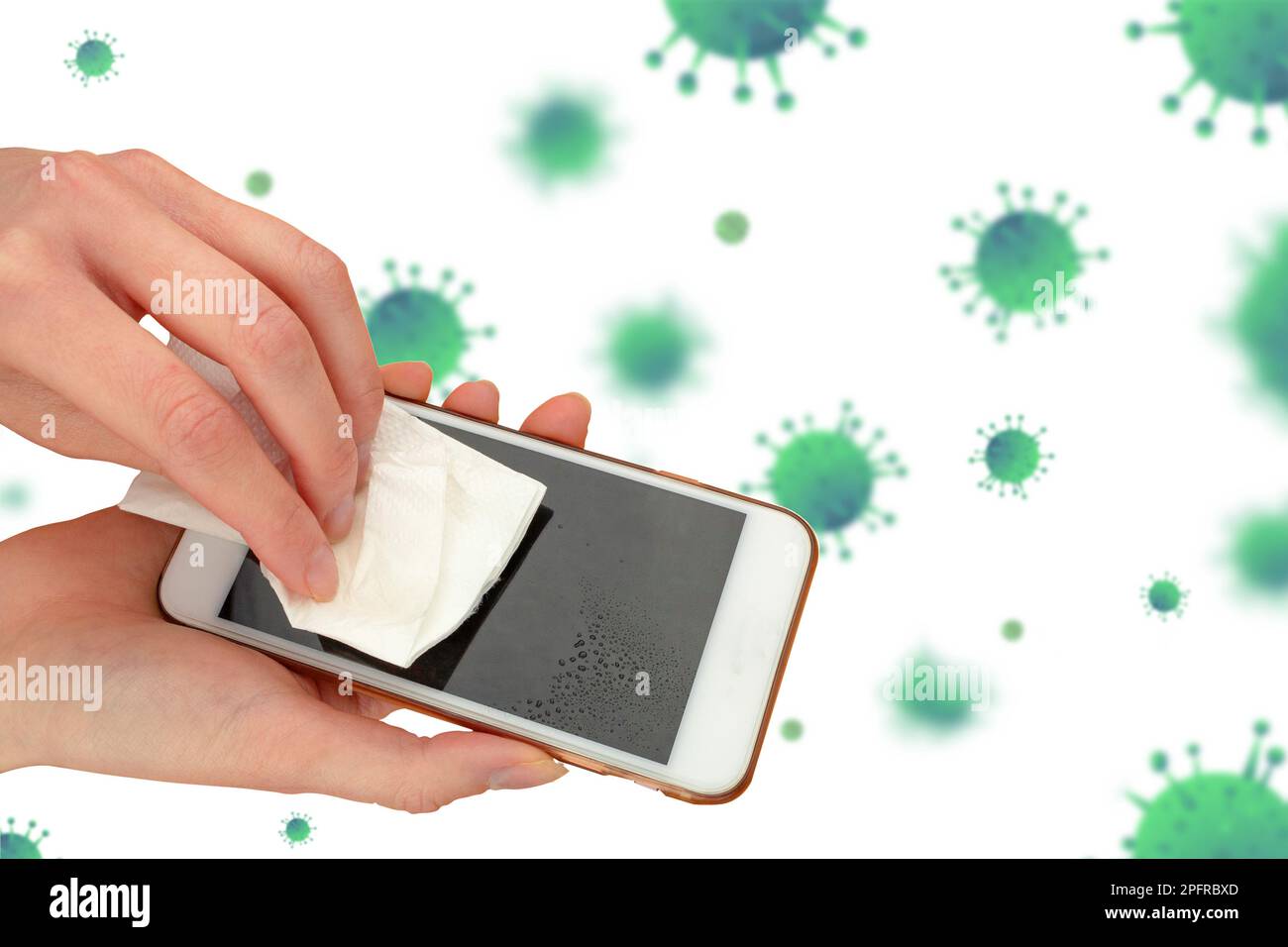 Hands wiping the phone screen with an antibacterial wipe. Closeup