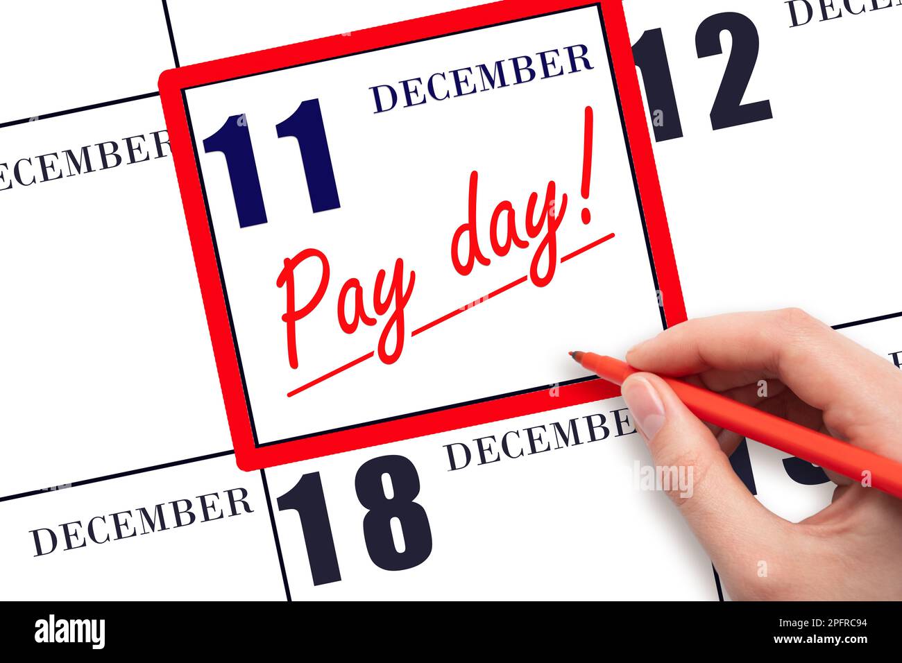 11th day of December. Hand writing text PAY DATE on calendar date December 11 and underline it. Payment due date.  Reminder concept of payment. Winter Stock Photo
