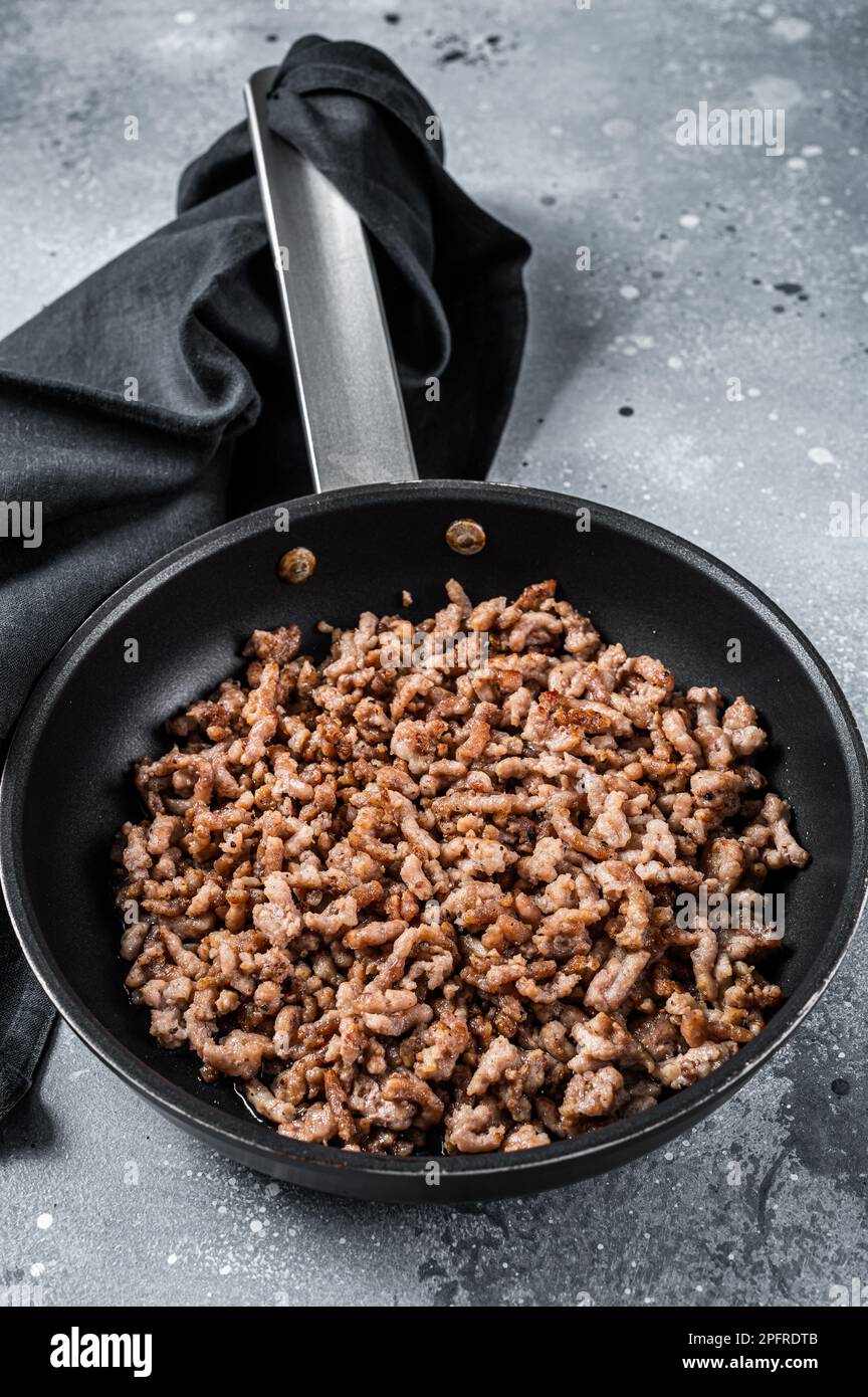 Pan fried minced meat to Italian pasta. Gray background. Top view Stock