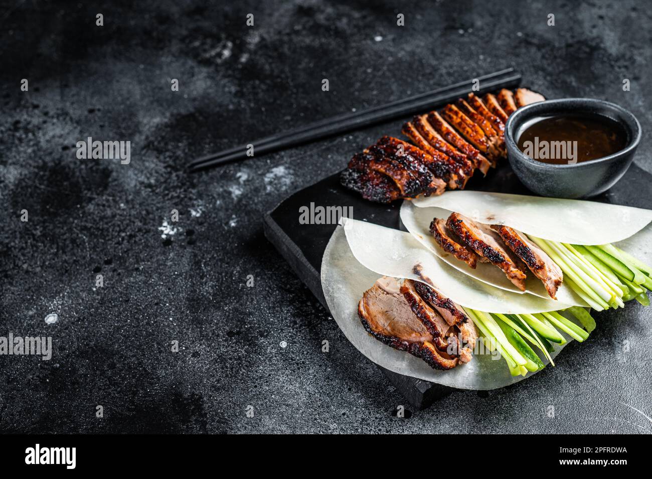 Traditional served Peking Duck with cucumber, green onion, in wheaten