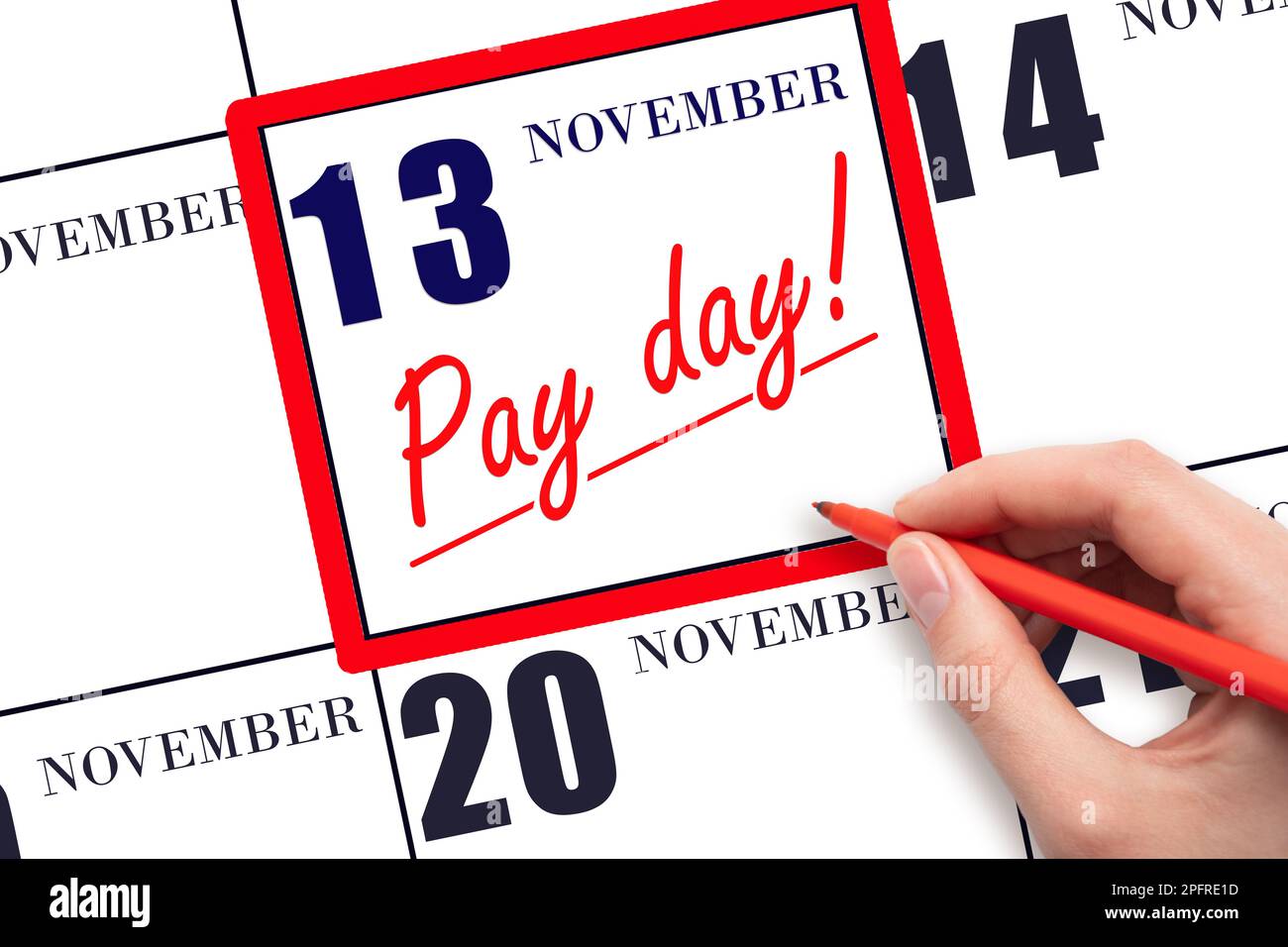 13th day of November. Hand writing text PAY DATE on calendar date November 13 and underline it. Payment due date.  Reminder concept of payment. Autumn Stock Photo