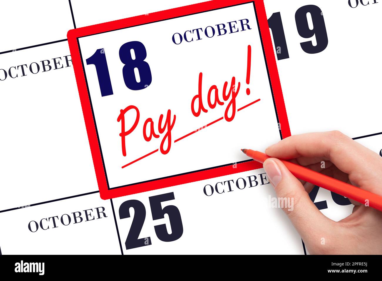 18th day of October. Hand writing text PAY DATE on calendar date October 18 and underline it. Payment due date.  Reminder concept of payment. Autumn m Stock Photo