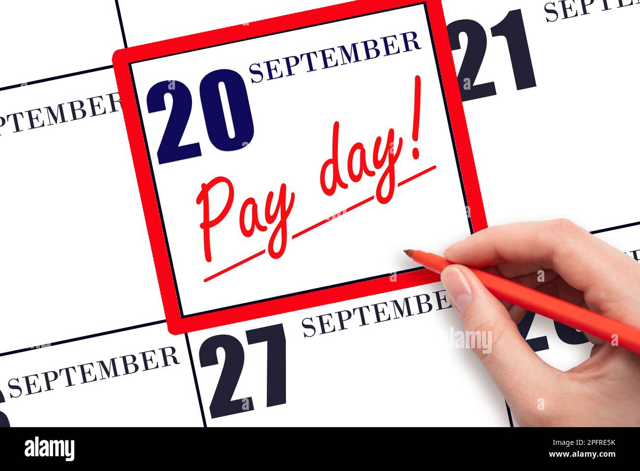 20th day of September. Hand writing text PAY DATE on calendar date September  20 and underline it. Payment due date.  Reminder concept of payment. Aut Stock Photo