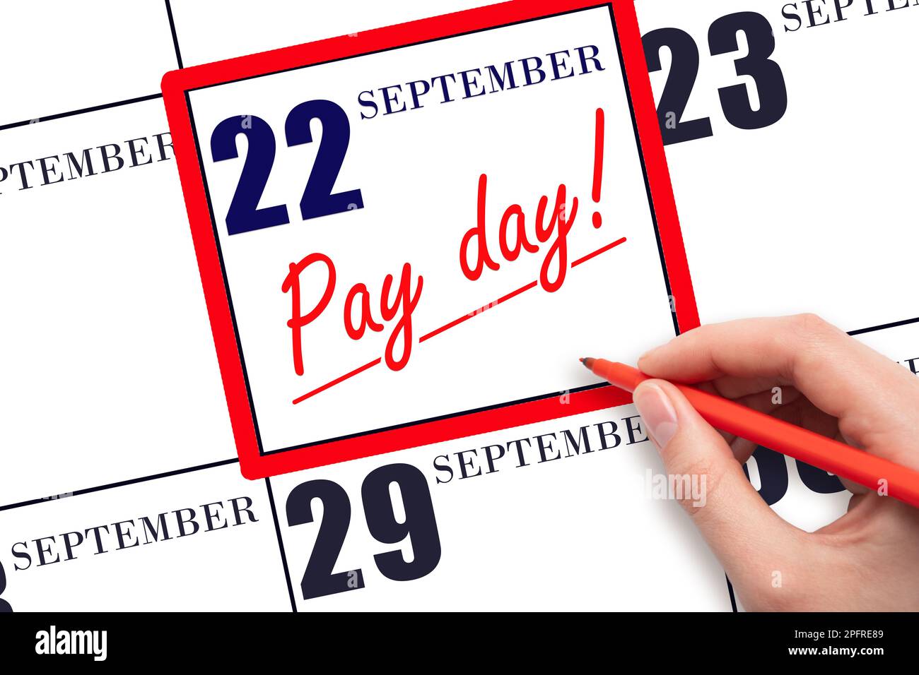 22nd day of September. Hand writing text PAY DATE on calendar date September  22 and underline it. Payment due date.  Reminder concept of payment. Aut Stock Photo
