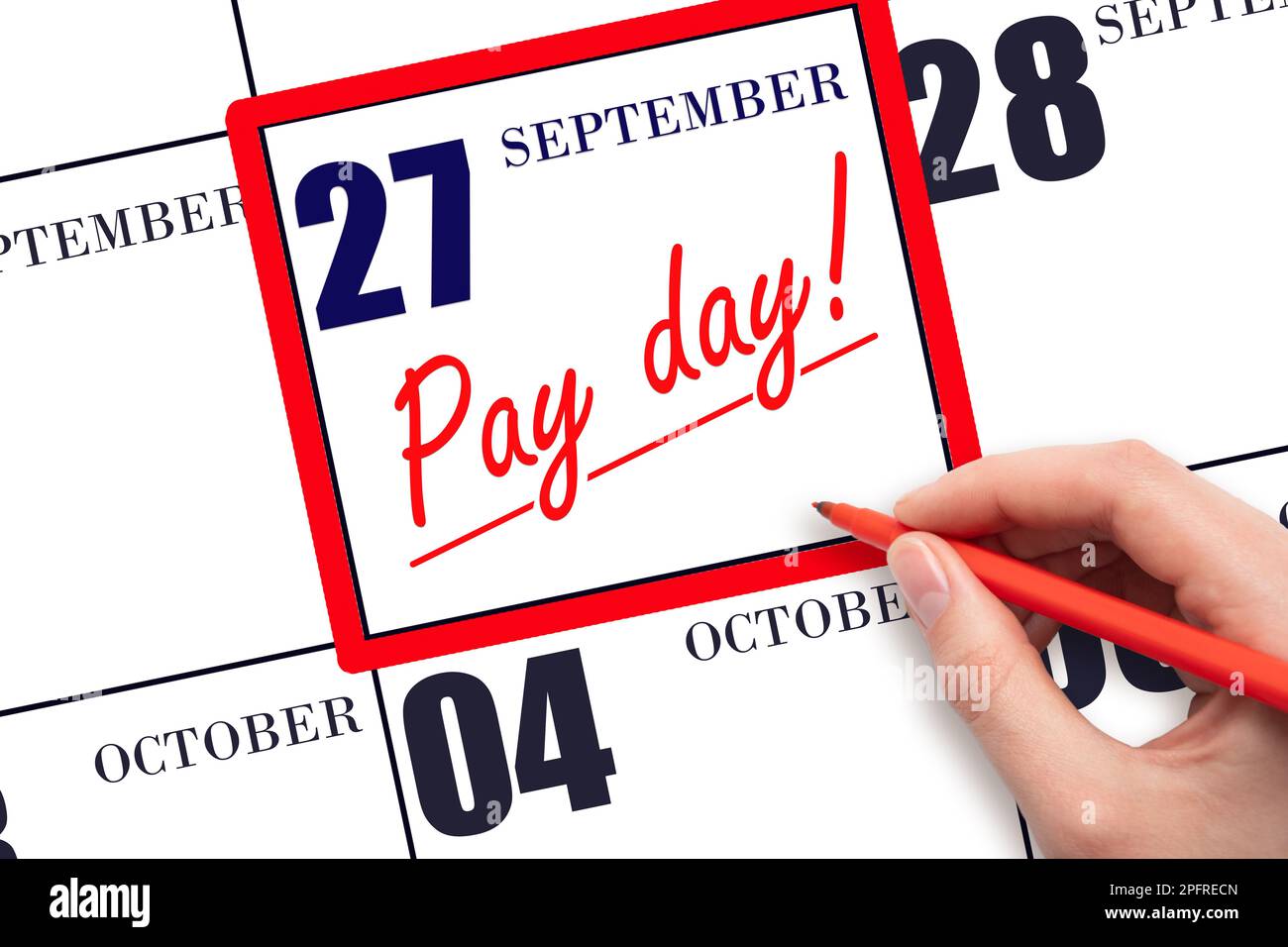 27th day of September. Hand writing text PAY DATE on calendar date September  27 and underline it. Payment due date.  Reminder concept of payment. Aut Stock Photo