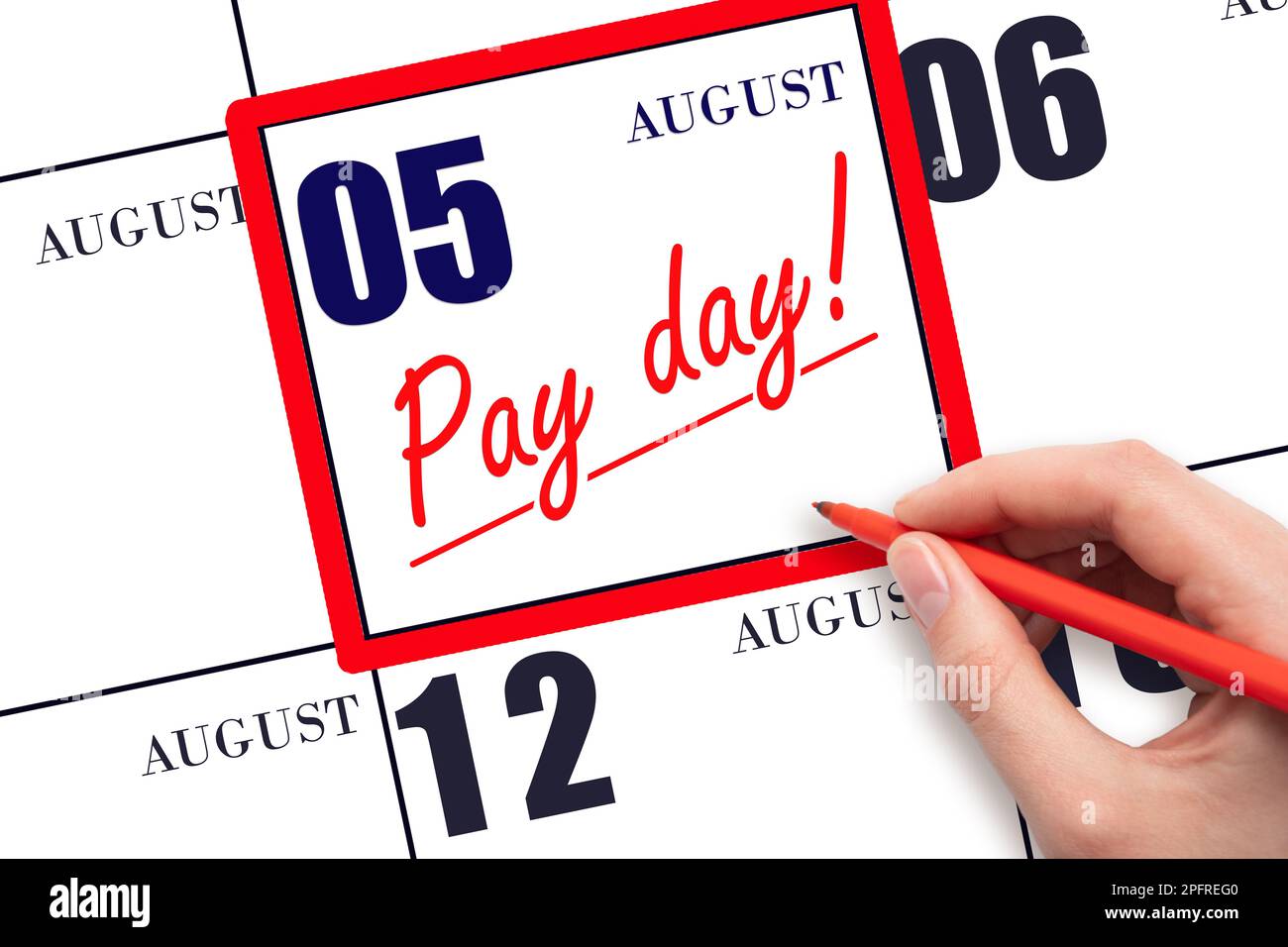 5th day of August. Hand writing text PAY DATE on calendar date August 5 and underline it. Payment due date.  Reminder concept of payment. Summer month Stock Photo
