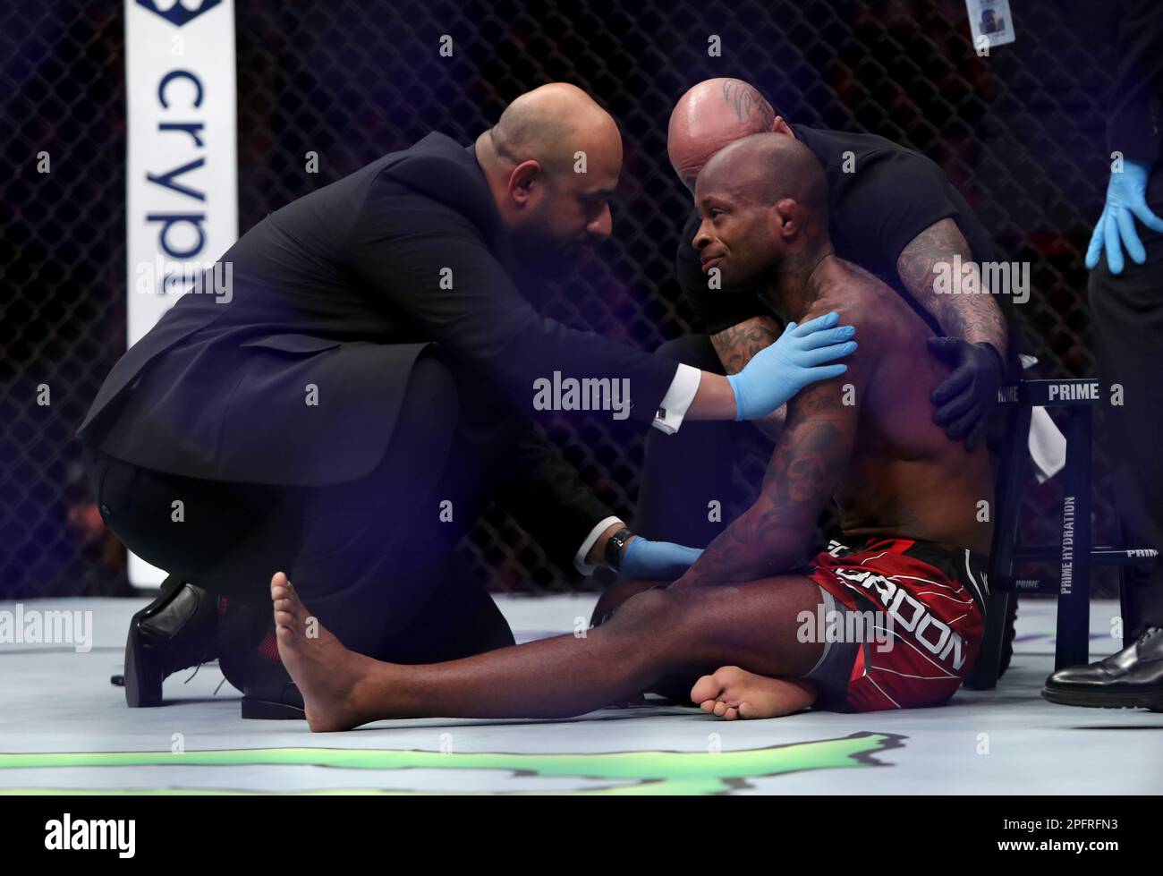 Canada's Malcolm Gordon (centre) is seen to by officials after the referee ended his Men's Flyweight bout against United Kingdom's Jake Hadley during UFC 286 at 02 Arena, London Picture date: Saturday March 18, 2023. Stock Photo
