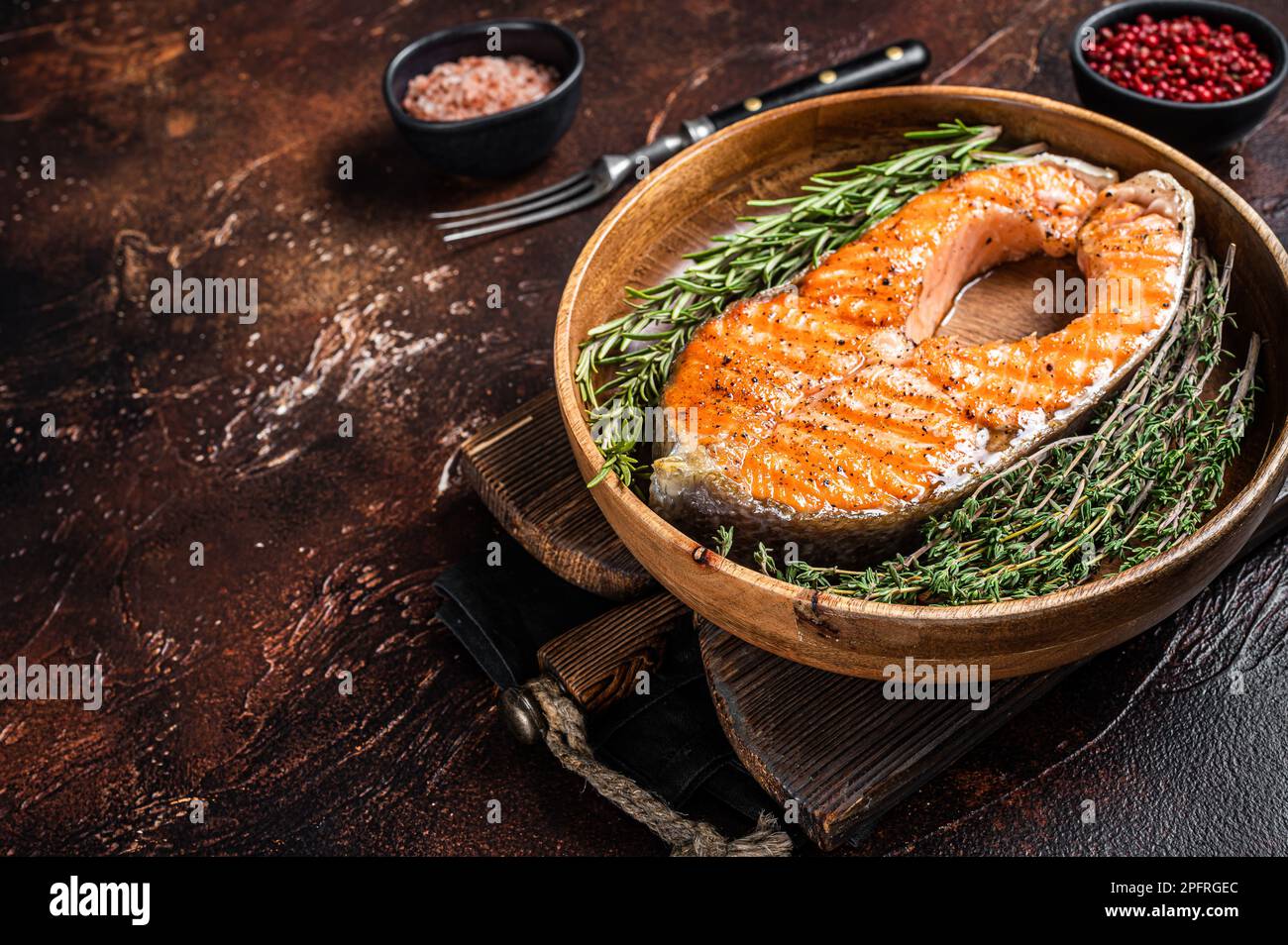 Roasted Salmon Trout Fish Steak in a vintage wooden plate with thyme ...