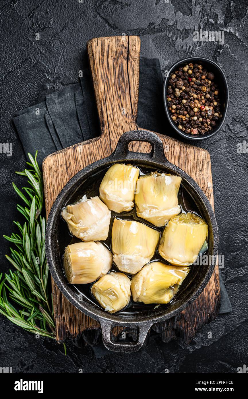 Artichoke hearts pickled in olive oil with herbs and spices Black
