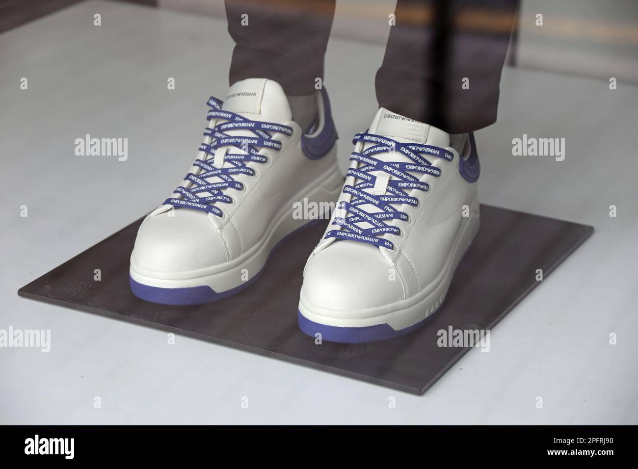 Soft leather sneakers by Armani with logo laces in a shop window Stock Photo