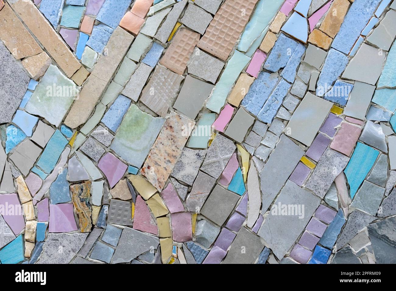 Mosaic of colored tiles and natural stones. Ceramic mosaic background. Stock Photo