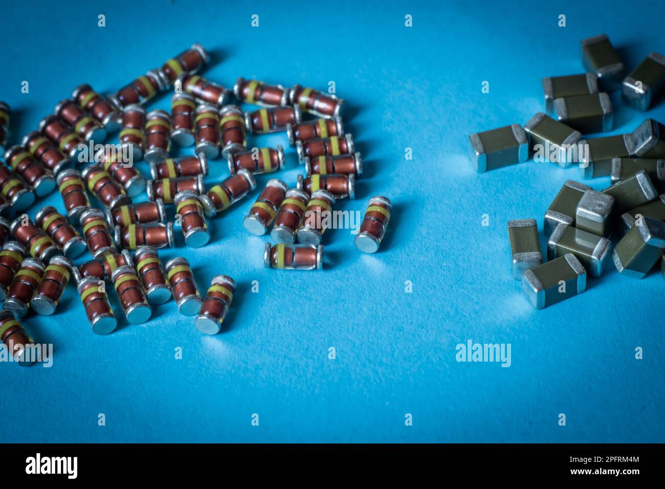 SMD diodes and smd ceramic capacitors, on a table with a blue