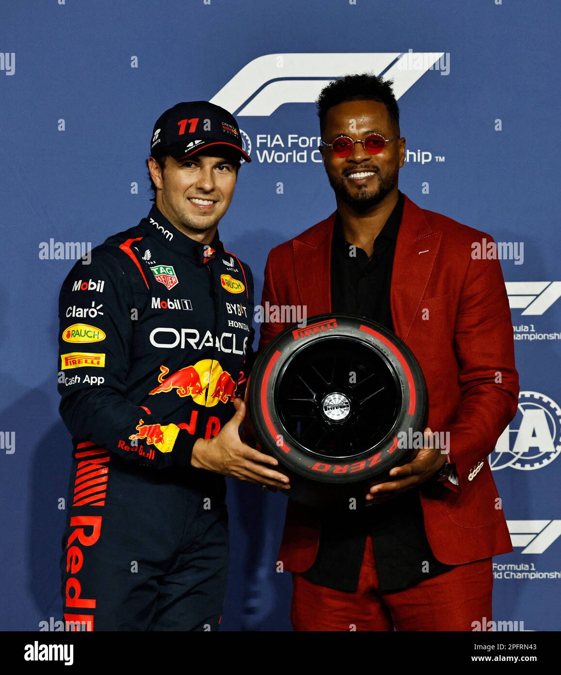 Formula One F1 - Saudi Arabian Grand Prix - Jeddah Corniche Circuit, Jeddah, Saudi Arabia - March 18, 2023 Red Bull's Sergio Perez is presented with the pole position trophy by former footballer Patrice Evra REUTERS/Hamad I Mohammed Stock Photo