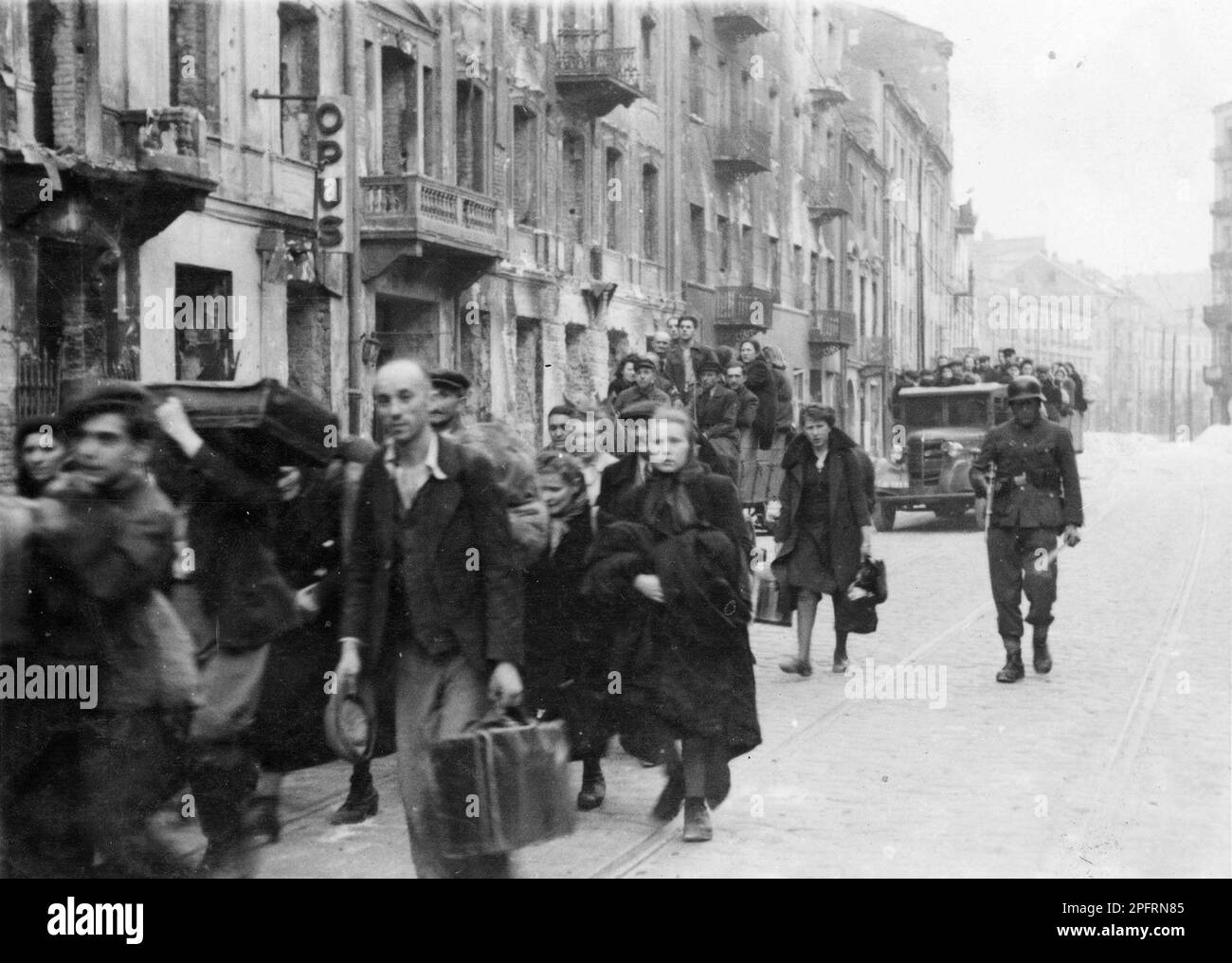 In January 1943 the nazis arrived to round up the Jews of the Warsaw Ghetto  The Jews, resolved to fight it out, took on the SS with homemade and primitive weapons. The defenders were executed or deported and the Ghetto area was systematically demolished. This event is known as The Ghetto Uprising. This image shows a column of Jews being marched out of the city ready for shipping to the death camps. This image is from the German photographic record of the event, known as the Stroop report. Stock Photo